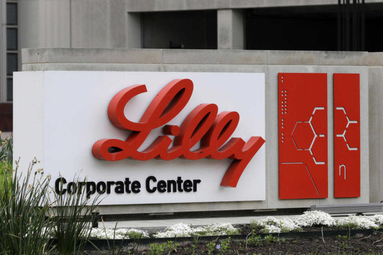 FILE - A sign for Eli Lilly & Co. sits outside their corporate headquarters in Indianapolis on April 26, 2017. New research shows another experimental Alzheimer's drug can modestly slow patients' inevitable worsening. Patients given monthly infusions of Eli Lilly and Co.'s donanemab declined about four to seven months more slowly than those given dummy infusions in a large study.