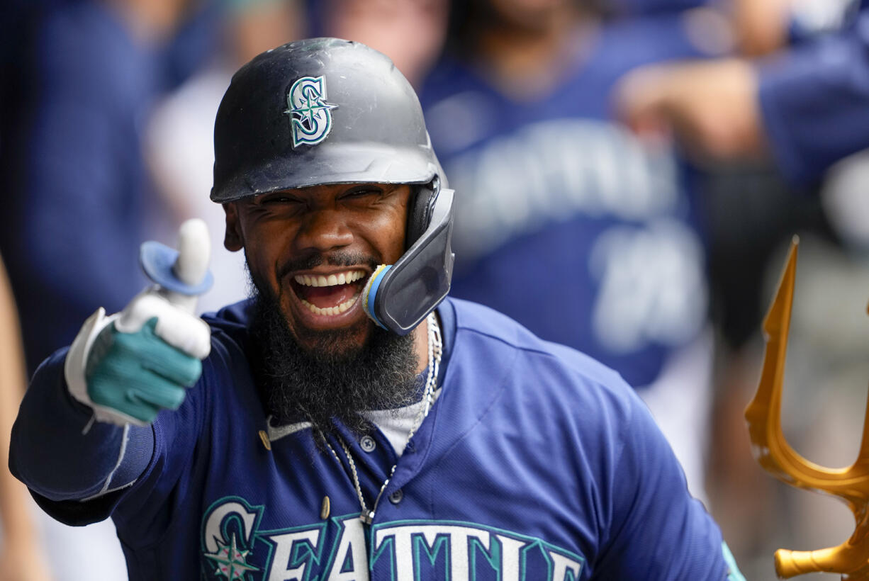 Seattle Mariners' Teoscar Hernandez gives a thumbs up as he celebrates in the dugout after hitting a three-run home run against the Oakland Athletics during the third inning of a baseball game, Wednesday, Aug. 30, 2023, in Seattle.