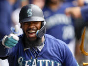 Seattle Mariners' Teoscar Hernandez gives a thumbs up as he celebrates in the dugout after hitting a three-run home run against the Oakland Athletics during the third inning of a baseball game, Wednesday, Aug. 30, 2023, in Seattle.