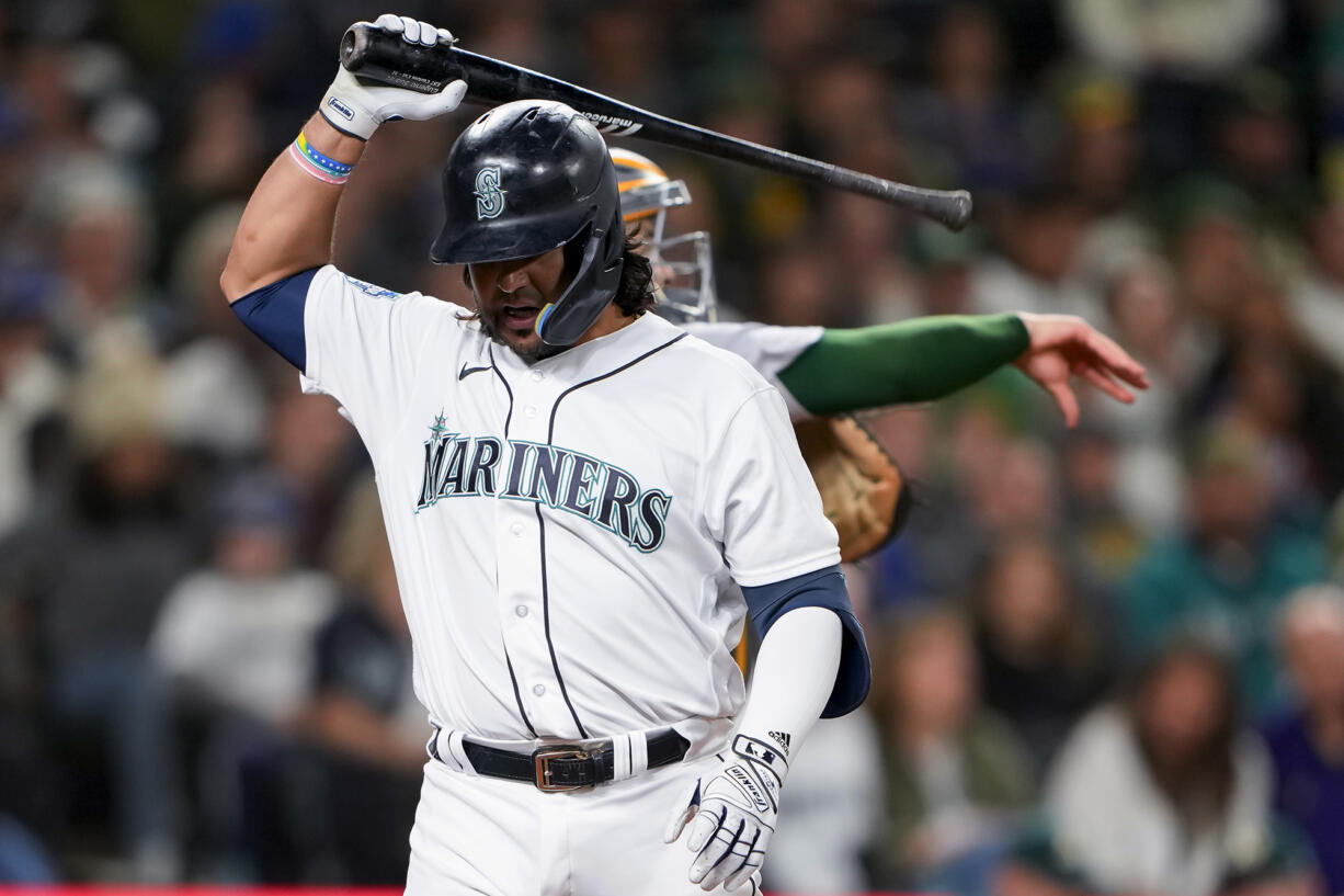 Seattle Mariners' Eugenio Suarez prepares to throw his bat to the ground after striking out against the Oakland Athletics during the seventh inning of a baseball game Tuesday, Aug. 29, 2023, in Seattle.