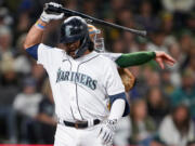 Seattle Mariners' Eugenio Suarez prepares to throw his bat to the ground after striking out against the Oakland Athletics during the seventh inning of a baseball game Tuesday, Aug. 29, 2023, in Seattle.