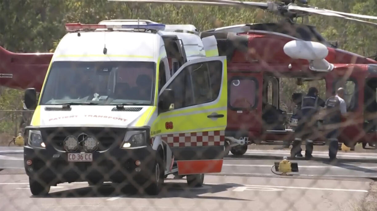 This image made from video shows a helicopter and ambulance involved in rescue mission, following an aircraft crash, in Darwin, Australia, Sunday, Aug. 27, 2023. Three United States military personnel were taken to a hospital, one with critical injuries, after a U.S. aircraft crashed on a north Australian island Sunday during a multination military exercise, officials said.