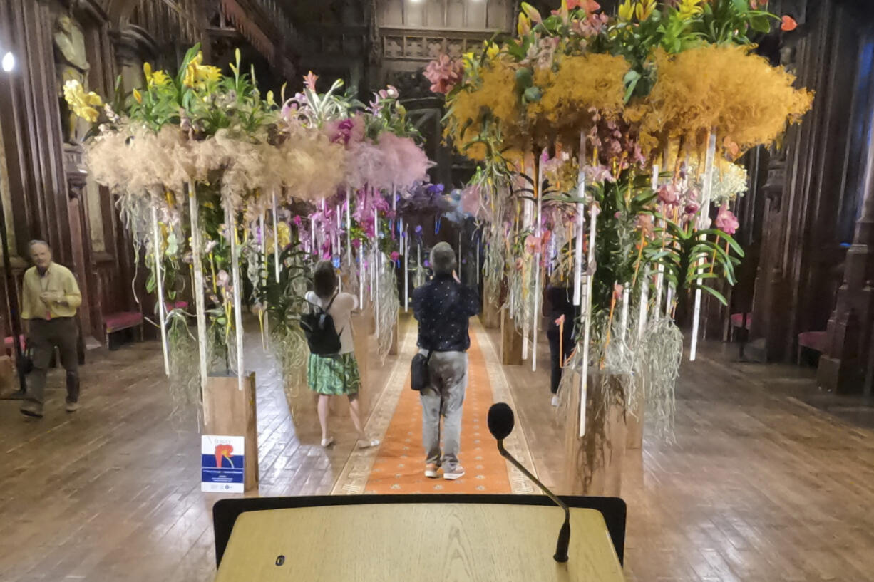 Visitors photograph the interior of City Hall decorated with flowers Friday in Brussels, Belgium. Belgium has a century-old fling with surrealism and is always proud to flaunt it.