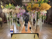 Visitors photograph the interior of City Hall decorated with flowers Friday in Brussels, Belgium. Belgium has a century-old fling with surrealism and is always proud to flaunt it.