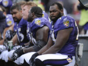 FILE - Baltimore Ravens offensive tackle Michael Oher sits on the beach during the first half of an NFL football game against the Buffalo Bills in Baltimore, Sunday, Oct. 24, 2010.