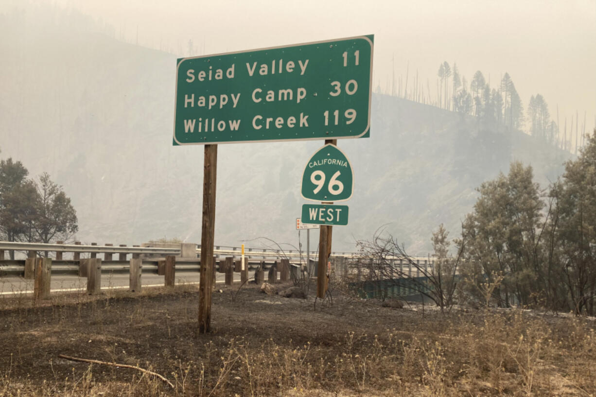 In this photo provided by Caltrans, smoke from the Head Fire blankets the closed State Route 96 in Klamath National Forest, Calif., on Wednesday, Aug. 16, 2023. Rural areas near California's border with Oregon were under evacuation orders Wednesday after gusty winds from a thunderstorm sent a lightning-sparked wildfire racing through national forest lands, authorities said. The blaze in Siskiyou County was one of at least 20 fires that erupted as thunderstorms brought lightning and downdrafts that drove the flames through timber and rural lands.