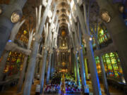 Worshippers attend a Mass July 9 in the Sagrada Familia basilica in Barcelona, Spain. With tourism reaching or surpassing pre-pandemic levels across southern Europe this summer, iconic sacred sites struggle to find ways to accommodate both the faithful who come to pray and millions of increasingly secular visitors attracted by art and architecture.