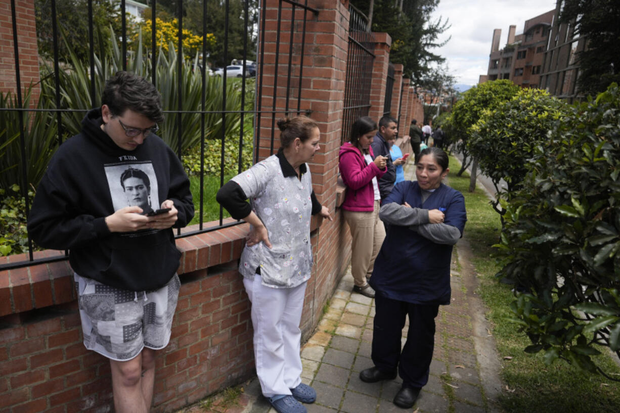 Residents gather outside their homes after a quake was felt in Bogota, Colombia, Thursday, Aug. 17, 2023.  A magnitude 6.3 earthquake shook Colombia's capital and other major cities on Thursday, according to reports by United States Geological service. USGS reported a second 5.7 magnitude quake shortly after the first.