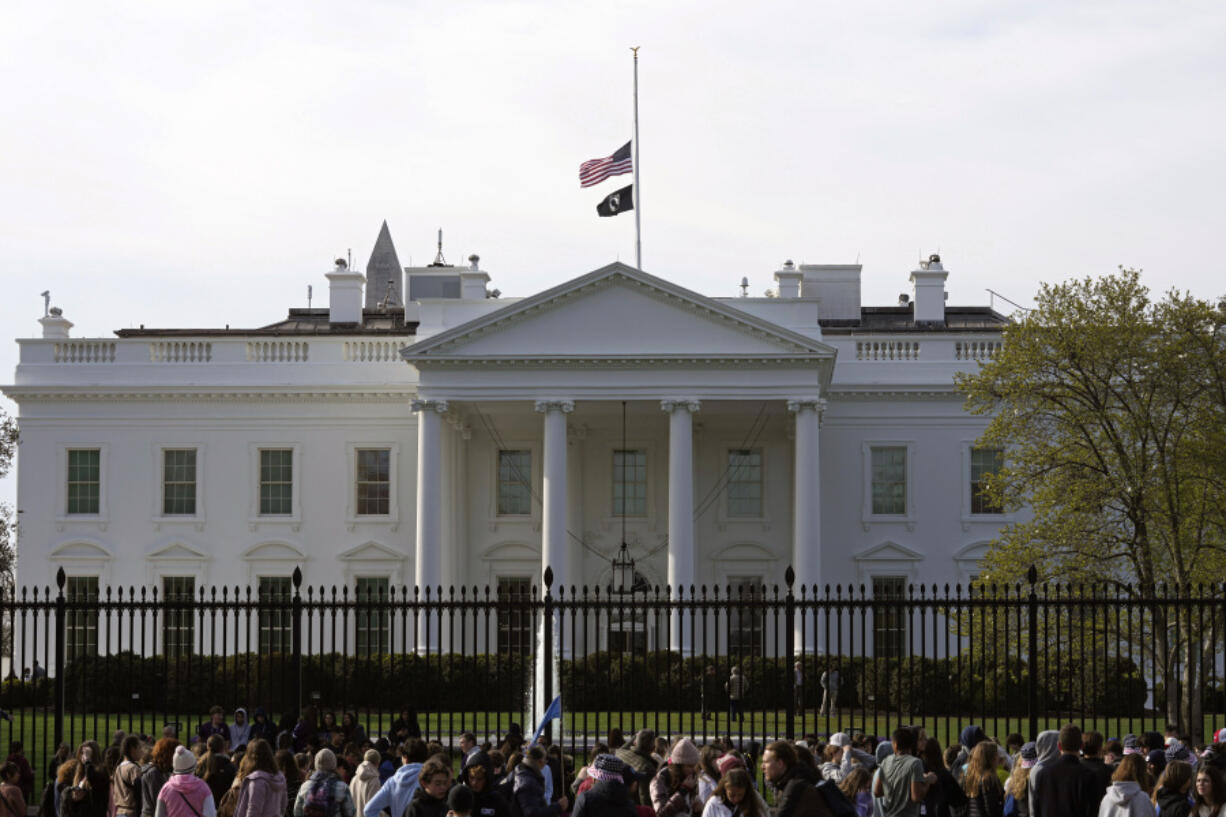 FILE - People walk past the White House in Washington, Tuesday, March 28, 2023. Unflattering portraits of both President Joe Biden and former President Donald Trump emerge clearly in a new poll by The Associated Press-NORC Center for Public Affairs Research, which asked an open-ended question about what comes to mind when people think of them.