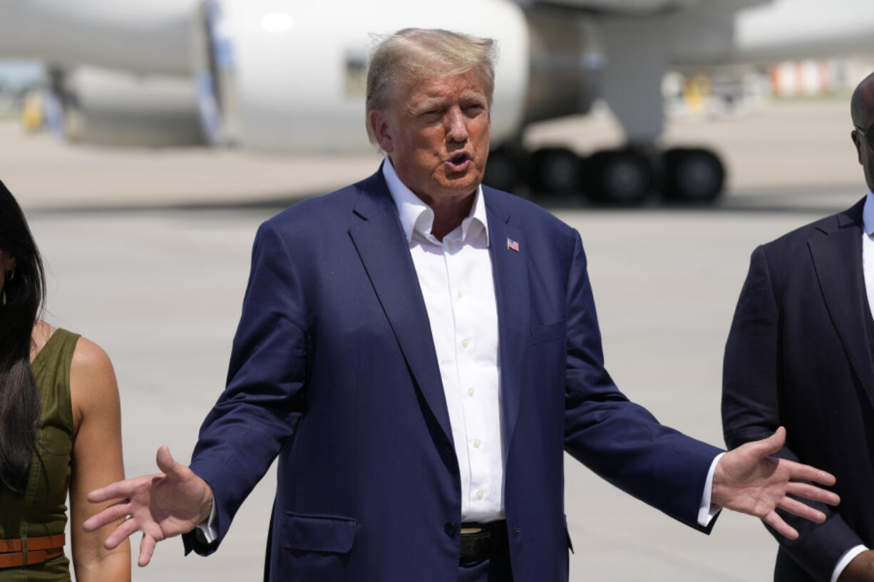 Republican presidential candidate former President Donald Trump speaks to reporters at the Des Moines International Airport after a visit to the Iowa State Fair, Saturday, Aug. 12, 2023, in Des Moines, Iowa.