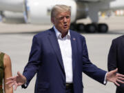 Republican presidential candidate former President Donald Trump speaks to reporters at the Des Moines International Airport after a visit to the Iowa State Fair, Saturday, Aug. 12, 2023, in Des Moines, Iowa.