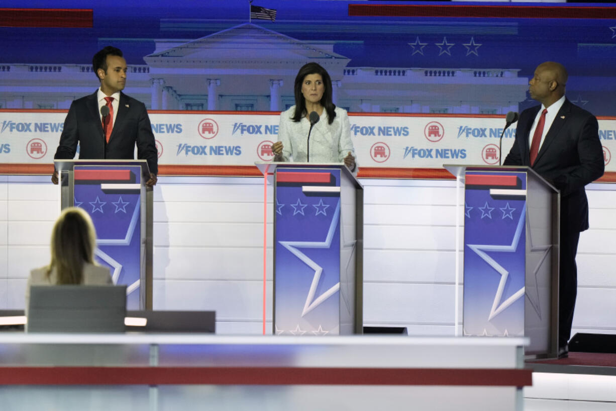 FILE - Former U.N. Ambassador Nikki Haley speaks as businessman Vivek Ramaswamy and Sen. Tim Scott, R-S.C., listen during a Republican presidential primary debate hosted by FOX News Channel, Wednesday, Aug. 23, 2023, in Milwaukee.