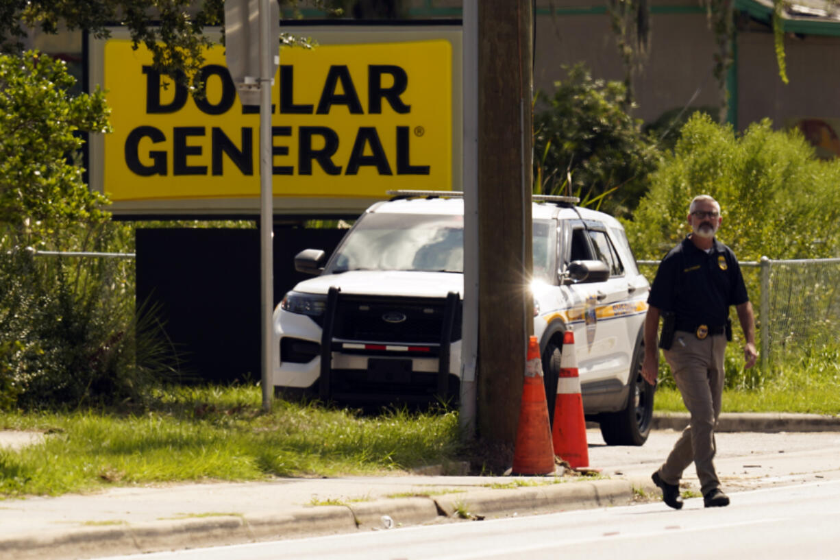 Law enforcement officials continue their investigation at a Dollar General Store that was the scene of a mass shooting, Sunday, Aug. 27, 2023, in Jacksonville, Fla.