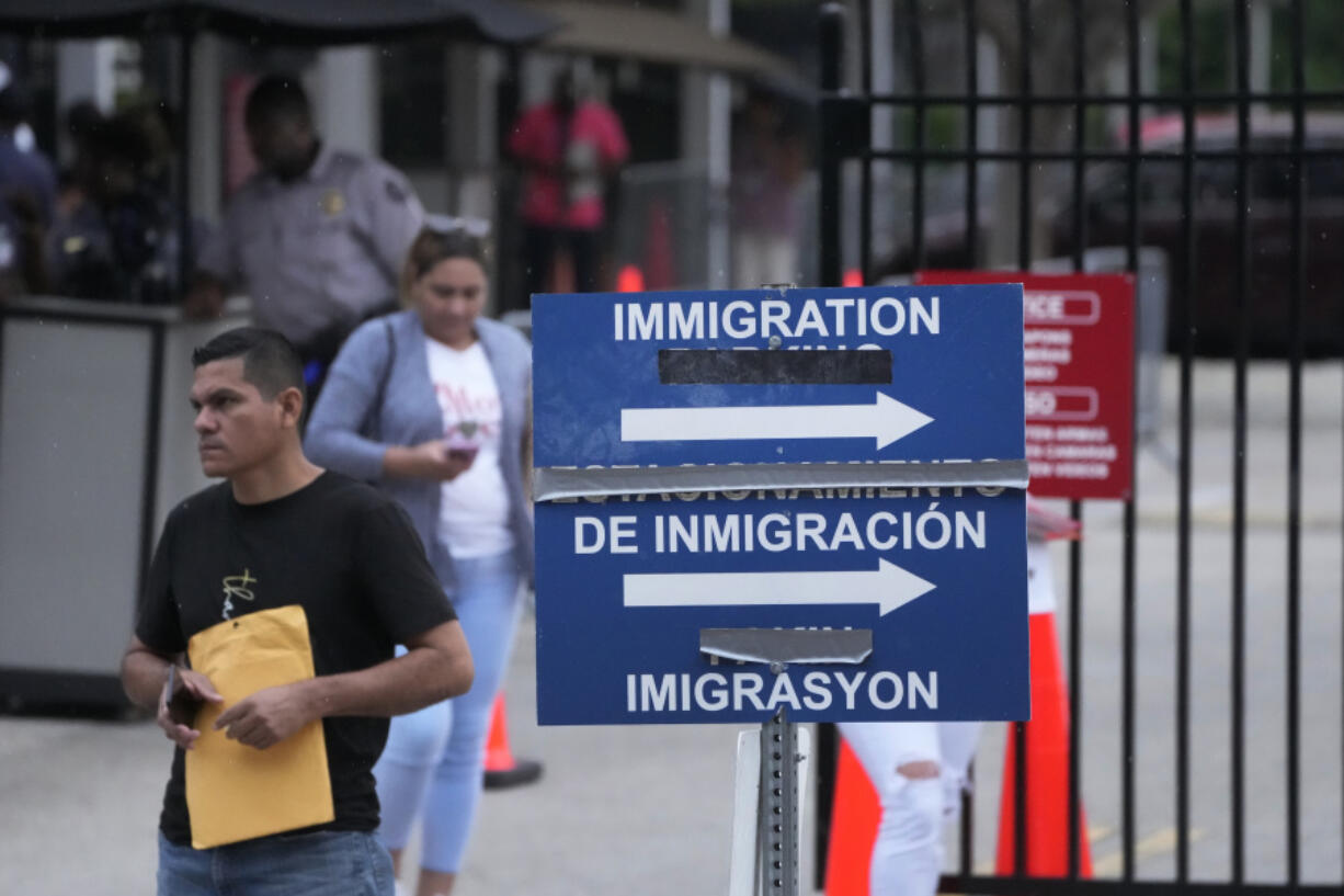 People leave the Immigration and Customs Enforcement (ICE) offices, Wednesday, July 26, 2023, in Miramar, Fla.