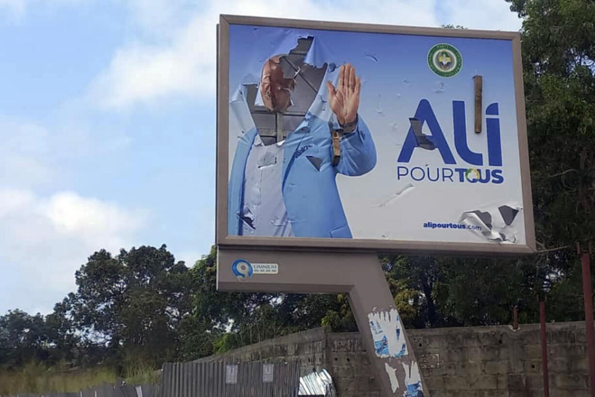 A defaced billboard of Gabon President Ali Bongo Ondimba is seen on an empty street in Libreville, Gabon, Wednesday Aug. 30, 2023. Mutinous soldiers speaking on state television announced that they had seized power in and were overturning the results of a presidential election that was to extend the Bongo family's 55-year hold on power.