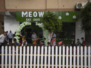 Palestinians gather for the opening ceremony of Meow Cafe in Gaza City, Thursday, Aug 17, 2023. Amidst the challenges of life in the Gaza Strip, constrained by a 17-year blockade and ongoing conflicts, this first-ever cat cafe offers a unique space for relaxation and positive human-animal interaction.