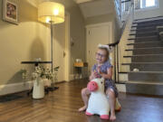 Brynn Schulte rides on a toy unicorn at her home in Cincinnati shortly before getting medication to treat her rare genetic bleeding disorder, Aug. 3, 2023. Brynn was diagnosed thanks to whole genome testing, which was recently shown to be nearly twice as good at finding genetic disorders in sick babies as more targeted tests. Her parents and doctors credit early diagnosis with saving her life.