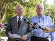 John Eastman, left, an attorney indicted with former President Donald Trump, makes a statement to press alongside his attorney, David Wolfe, outside the Fulton County Jail in Atlanta, where he was booked on Tuesday, Aug. 22, 2023.