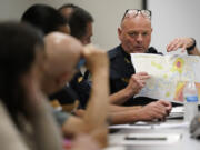 Knoxville Deputy Police Chief Tony Willis uses a map to show the concentration of gun violence crimes during a meeting of the Violence Reduction Leadership Committee on Thursday, Aug. 3, 2023, in Knoxville, Tenn. The city saw a spike in gun deaths in 2020 and 2021, with a gun homicide rate that at one point in 2021 rivaled Chicago's.