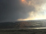 In this photo provided by Anne Landon, smoke fills the sky and blots out the sun as a deadly fire overtakes the town of Lahaina, on the Hawaiian island of Maui, Tuesday, Aug. 8, 2023. The lahaina resident was able to escape her senior apartment complex with her life. But many people, families, homes and an entire town were lost in the inferno.