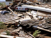 FILE - A car and a pickup truck are buried in the rubble of what was once a home on the island of Kauai, on Sept. 14, 1992. Two-thirds of the single family homes on Hawaii's most populous island have no hurricane protections. This year's return of El Nino is highlighting this weakness because it boosts the odds that more tropical cyclones will travel through Hawaii's waters this summer and fall.