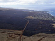 FILE - Wildfire devastation is seen outside the city Lahaina, Hawaii, Aug. 10, 2023. Experts say the fires are likely to transform the landscape in unwanted ways, hasten erosion, send sediment into waterways and degrade coral that's critically important to the islands, marine life and people who live near it.