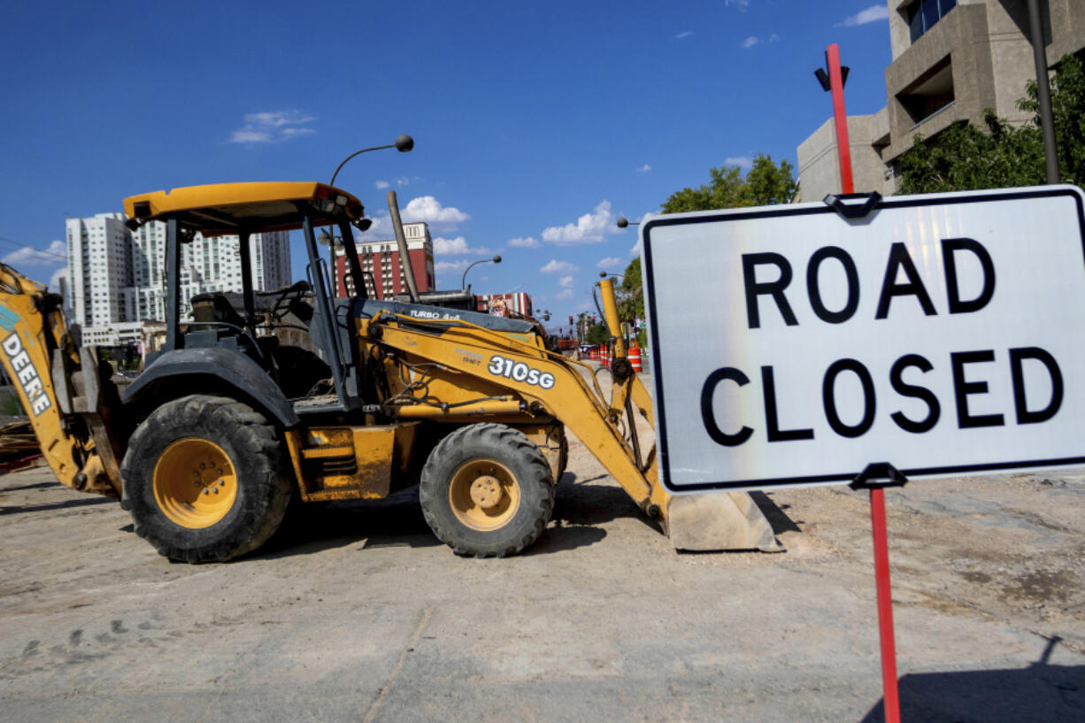 Heavy equipment is parked after working hours were shortened for heat, Friday, Aug. 25, 2023, in Las Vegas. A historic heat wave that began blasting the Southwest and other parts of the country this summer is shining a spotlight on one of the harshest, yet least-addressed, effects of climate change in the U.S.: the rising deaths and injuries of people who work in extreme heat, whether inside hot warehouses and kitchens or outside under the blazing sun. Many of them are migrants in low-wage jobs.