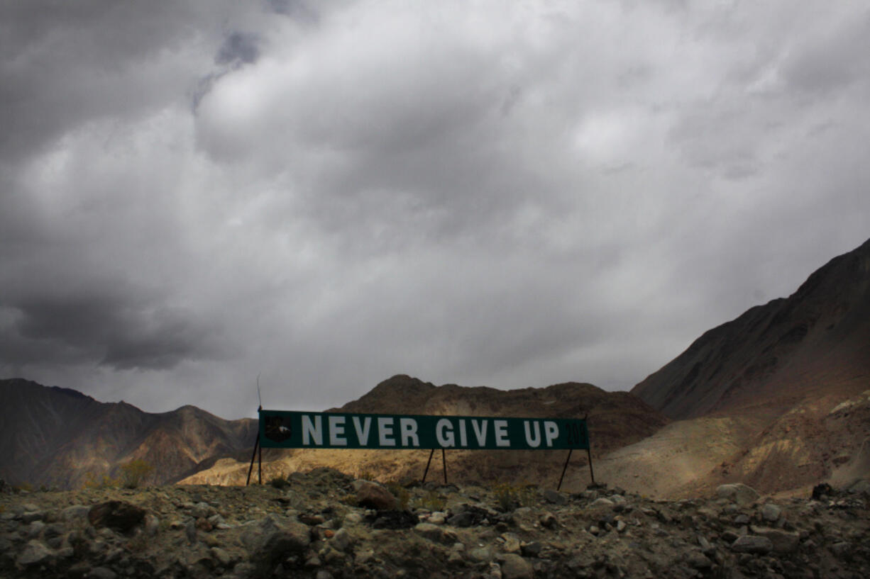 FILE- A banner erected by the Indian army stands near Pangong Tso lake near the India-China border in India's Ladakh area, Sept. 14, 2017. India is protesting a new Chinese map that lays claim to India's territory ahead of next week's Group of 20 summit in New Delhi, a foreign ministry official said on Tuesday, Aug. 29, 2023, exacerbating tensions during a three-year military standoff between the two nations. India says China occupies 38,000 square kilometers of its territory in the Aksai Chin Plateau, which India considers part of Ladakh, where the current faceoff is happening.