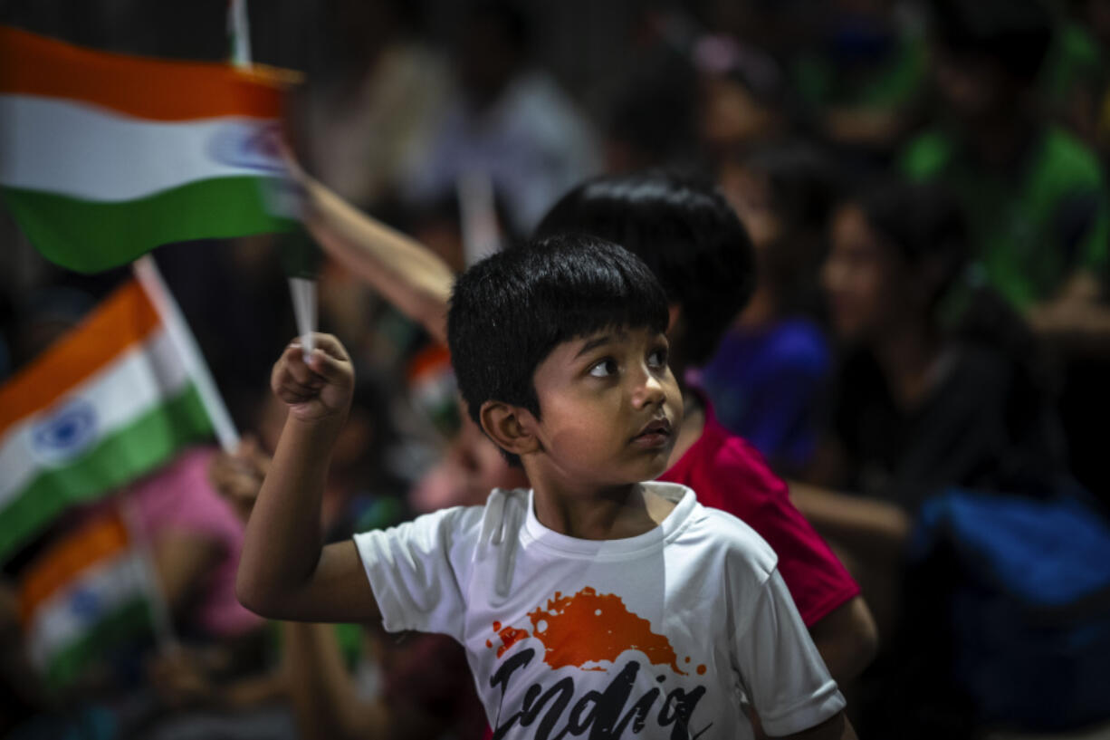 Schoolchildren celebrate the successful landing of spacecraft Chandrayaan-3 on the moon, in a school in Guwahati, India, Wednesday, Aug. 23, 2023. India has landed a spacecraft near the moon's south pole, an unchartered territory that scientists believe could hold vital reserves of frozen water and precious elements, as the country cements its growing prowess in space and technology.