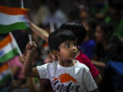 Schoolchildren celebrate the successful landing of spacecraft Chandrayaan-3 on the moon, in a school in Guwahati, India, Wednesday, Aug. 23, 2023. India has landed a spacecraft near the moon's south pole, an unchartered territory that scientists believe could hold vital reserves of frozen water and precious elements, as the country cements its growing prowess in space and technology.