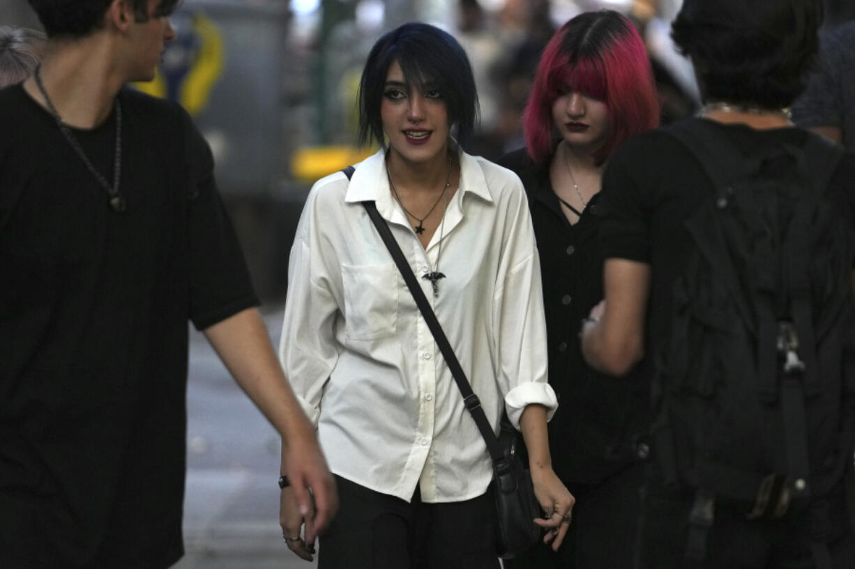 Iranian women walk in Tehran, Iran, Saturday, Aug. 5, 2023. These days, with uncovered women a common sight on Tehran streets, authorities have begun raiding companies where women employees or customers have been seen without the headscarf, or hijab. Iran's parliament is discussing a law that would increase punishments on uncovered women and the businesses they frequent.