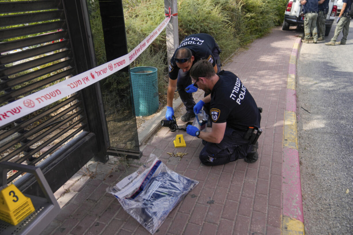 Israeli police inspect the site of a shooting attack in the West Bank Israeli settlement of Maale Adumim, Tuesday, Aug 1, 2023. A Palestinian gunman opened fire in an Israeli settlement east of Jerusalem on Tuesday, wounding at least four people, Israeli medics said. The Palestinian assailant was shot and killed by an off-duty Israeli police officer outside a shopping mall.