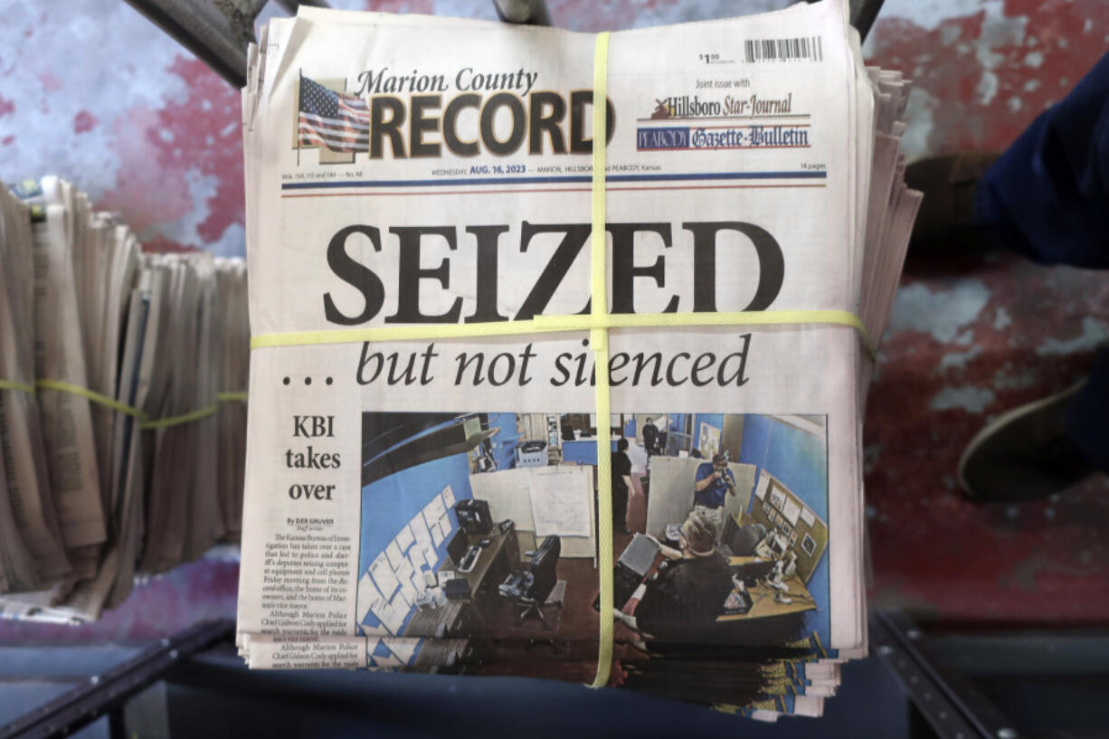 A stack of the latest weekly edition of the Marion County Record sits in the back of the newspaper's building, awaiting unbundling, sorting and distribution, Wednesday, Aug. 16, 2023, in Marion, Kan. The newspaper's front page was dedicated to two stories about a raid by local police on its offices and the publisher's home on Aug. 11, 2023.