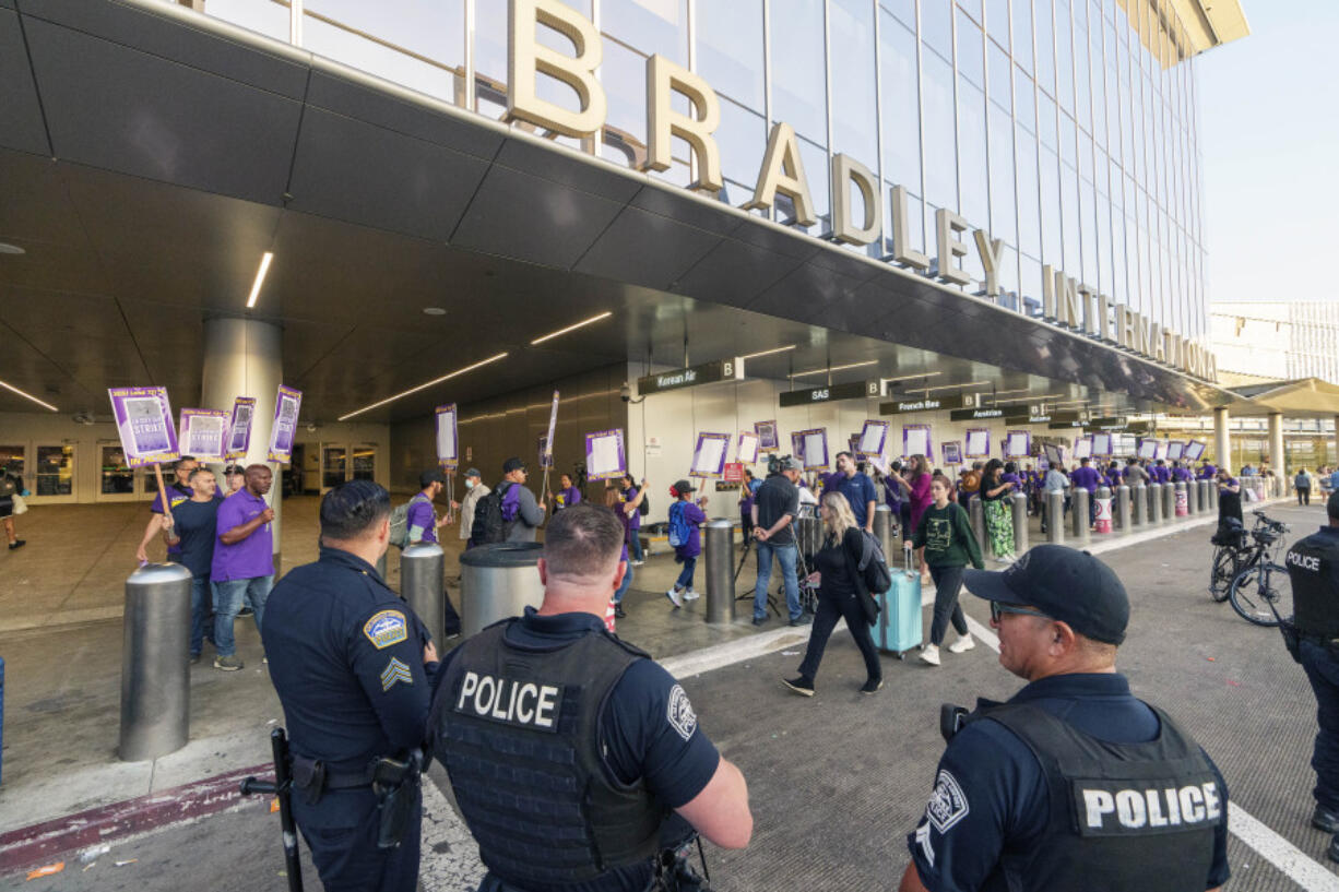 Workers with SEIU Local 721 - Southern California Public Service Workers join a picket line at the Los Angeles International Airport, LAX Tom Bradley International Terminal Terminal B in Los Angeles on Tuesday, Aug. 8, 2023. Thousands of Los Angeles city employees, including sanitation workers, engineers and traffic officers, walked off the job for a 24-hour strike alleging unfair labor practices. The union said its members voted to authorize the walkout because the city has failed to bargain in good faith and also engaged in labor practices that restricted employee and union rights.