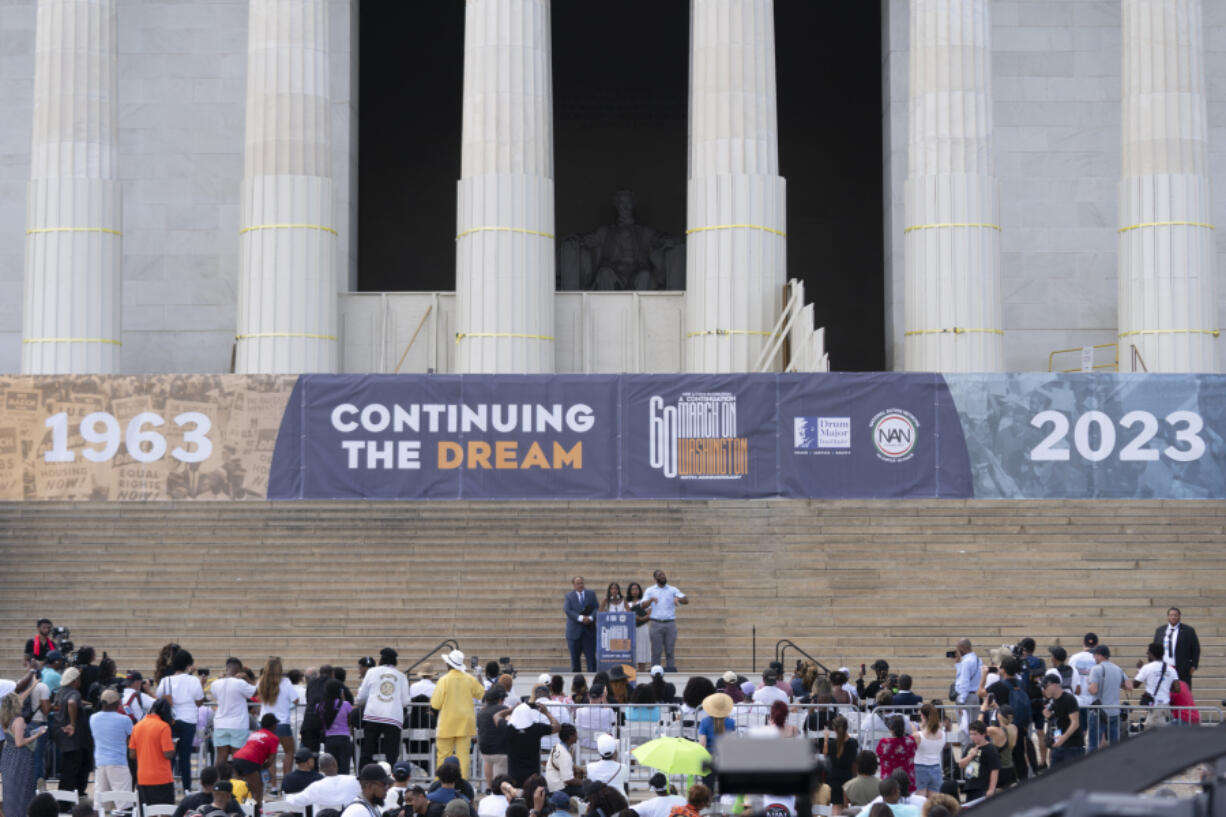 Martin Luther King III, the son of Martin Luther King Jr., left, and his wife Arndrea Waters King, second from right, look on as their daughter Yolanda King speaks during the 60th Anniversary of the March on Washington at the Lincoln Memorial in Washington, Saturday, Aug. 26, 2023.