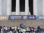 Martin Luther King III, the son of Martin Luther King Jr., left, and his wife Arndrea Waters King, second from right, look on as their daughter Yolanda King speaks during the 60th Anniversary of the March on Washington at the Lincoln Memorial in Washington, Saturday, Aug. 26, 2023.