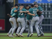 The Seattle Mariners infielders dance after a baseball game against the Houston Astros, Sunday, Aug. 20, 2023, in Houston. (AP Photo/Kevin M.