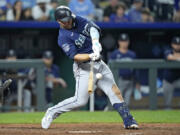 Seattle Mariners' Ty France hits a two-run single during the 10th inning of a baseball game against the Kansas City Royals Tuesday, Aug. 15, 2023, in Kansas City, Mo. The Mariners won 10-8 in 10 innings.