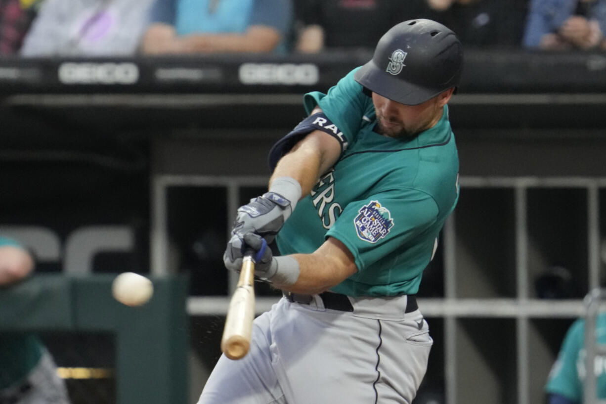 Seattle Mariners' Cal Raleigh hits a two-run double during the first inning of a baseball game against the Chicago White Sox in Chicago, Monday, Aug. 21, 2023. (AP Photo/Nam Y.