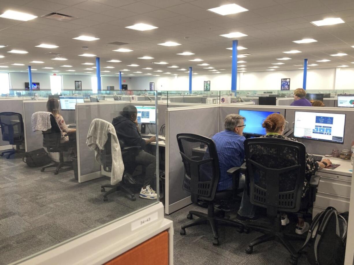 Workers at a Medicaid call center review information regarding eligibility determinations on Wednesday, Aug. 16, 2023 in Jefferson City, Mo. Federal Medicaid officials have raised concerns that call center wait times are too long in 16 states, including Missouri. States are handling an influx of questions after a pandemic-era moratorium on removing people from Medicaid ended this spring. (AP Photo/David A.