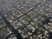 FILE - Homes remain surrounded by floodwaters in the aftermath of Hurricane Katrina, Sept. 11, 2005, in New Orleans. Hurricanes in the U.S. over last few decades killed thousands more people than meteorologists traditionally calculate and a disproportionate number of those victims are poor, vulnerable and minorities, according to a new epidemiological study released Wednesday, Aug. 16, 2023. (AP Photo/David J.