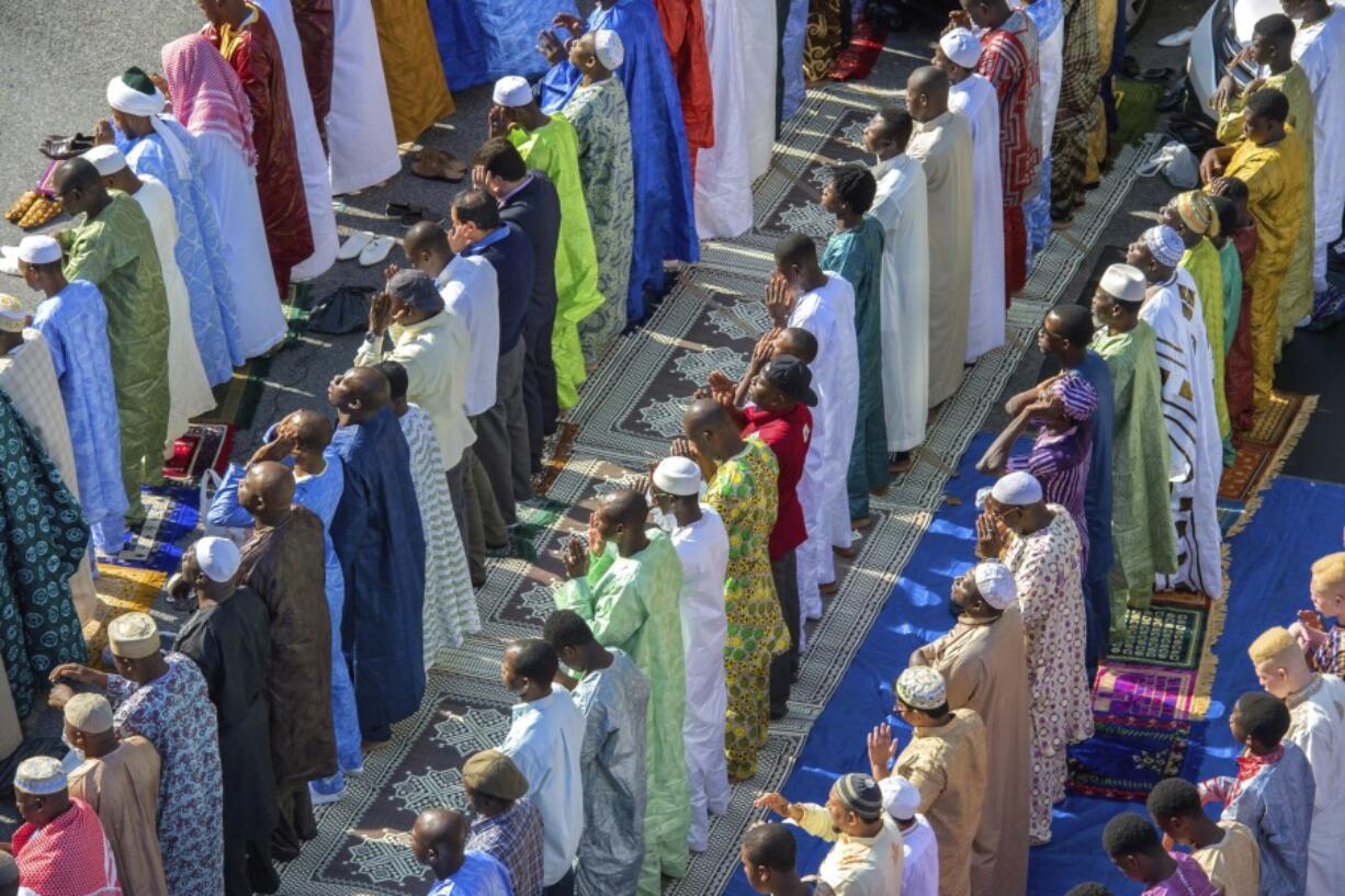 FILE -- Worshipers in New York's East Harlem neighborhood take part in the traditional annual prayer commemorating the end of Ramadan, in front of the Masjid Aqsa-Salam mosque, on July 17, 2015. New York Mayor Eric Adams announced new guidelines Tuesday, Aug. 29, 2023, allowing mosques to broadcast the Muslim call to prayer on Fridays and at sundown during the holy month of Ramadan. (AP Photo/Bryan R.