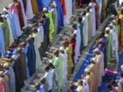 FILE -- Worshipers in New York's East Harlem neighborhood take part in the traditional annual prayer commemorating the end of Ramadan, in front of the Masjid Aqsa-Salam mosque, on July 17, 2015. New York Mayor Eric Adams announced new guidelines Tuesday, Aug. 29, 2023, allowing mosques to broadcast the Muslim call to prayer on Fridays and at sundown during the holy month of Ramadan. (AP Photo/Bryan R.