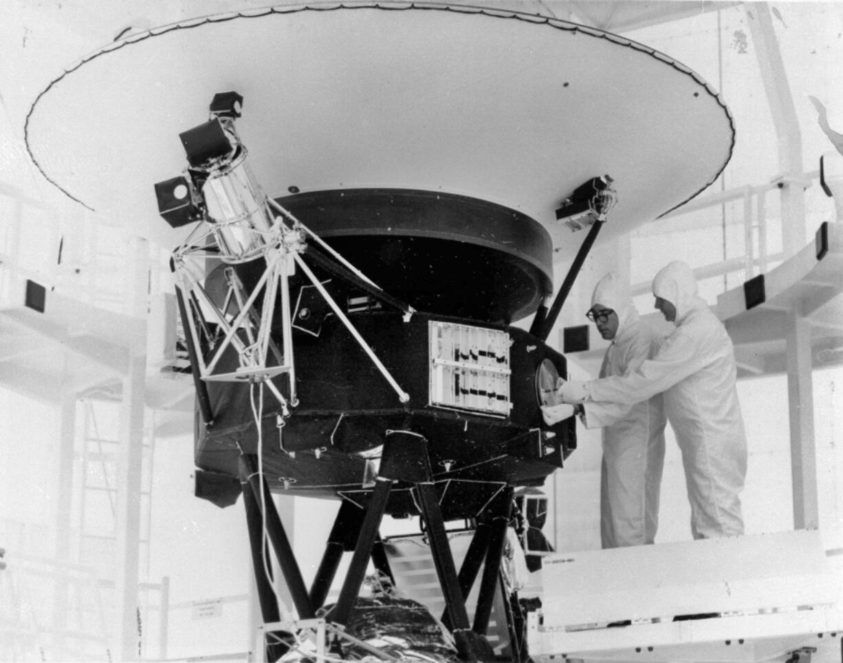 FILE - In this Aug. 4, 1977, photo provided by NASA, the "Sounds of Earth" record is mounted on the Voyager 2 spacecraft in the Safe-1 Building at the Kennedy Space Center, Fla., prior to encapsulation in the protective shroud. After days of silence, NASA has heard from Voyager 2, more than 12 billion miles away in interstellar space. Flight controllers accidentally sent a wrong command nearly two weeks ago that tilted the spacecraft's antenna away from Earth and severed contact. The project manager said Tuesday, Aug. 1, 2023 that the fact that the Deep Space Network has picked up a "heartbeat signal" means the 46-year-old craft is alive and operating.