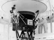 FILE - In this Aug. 4, 1977, photo provided by NASA, the "Sounds of Earth" record is mounted on the Voyager 2 spacecraft in the Safe-1 Building at the Kennedy Space Center, Fla., prior to encapsulation in the protective shroud. After days of silence, NASA has heard from Voyager 2, more than 12 billion miles away in interstellar space. Flight controllers accidentally sent a wrong command nearly two weeks ago that tilted the spacecraft's antenna away from Earth and severed contact. The project manager said Tuesday, Aug. 1, 2023 that the fact that the Deep Space Network has picked up a "heartbeat signal" means the 46-year-old craft is alive and operating.