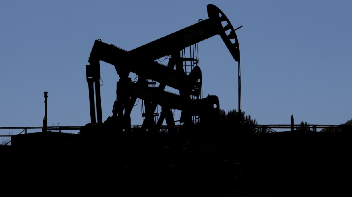 Pumpjacks dip their heads to extract oil in a basin south of Duchesne, Utah on Thursday, July 13, 2023. Uinta Basin Railway, one of the United States' biggest rail investments in more than a century, could be an 88-mile line in Utah that would run through tribal lands and national forest to move oil and gas to the national rail network. Critics question investing billions in oil and gas infrastructure as the country seeks to use less of the fossil fuels that worsen climate change.