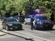 A police officer tapes off a crime scene on Saturday, July 22, 2023, after a shooting at Legacy Good Samaritan Medical Center in Portland, Ore. Gunfire erupted in a maternity unit of the Oregon hospital last weekend, fatally wounding an unarmed security guard and leading to renewed calls Monday, July 24,  to protect health care workers from increasing violence.