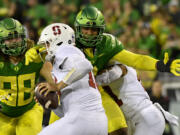 Oregon defensive end Brandon Dorlus (3) sacks Stanford quarterback Tanner McKee last season in Eugene, Ore. Oregon's fortunes will rest largely on its defense.