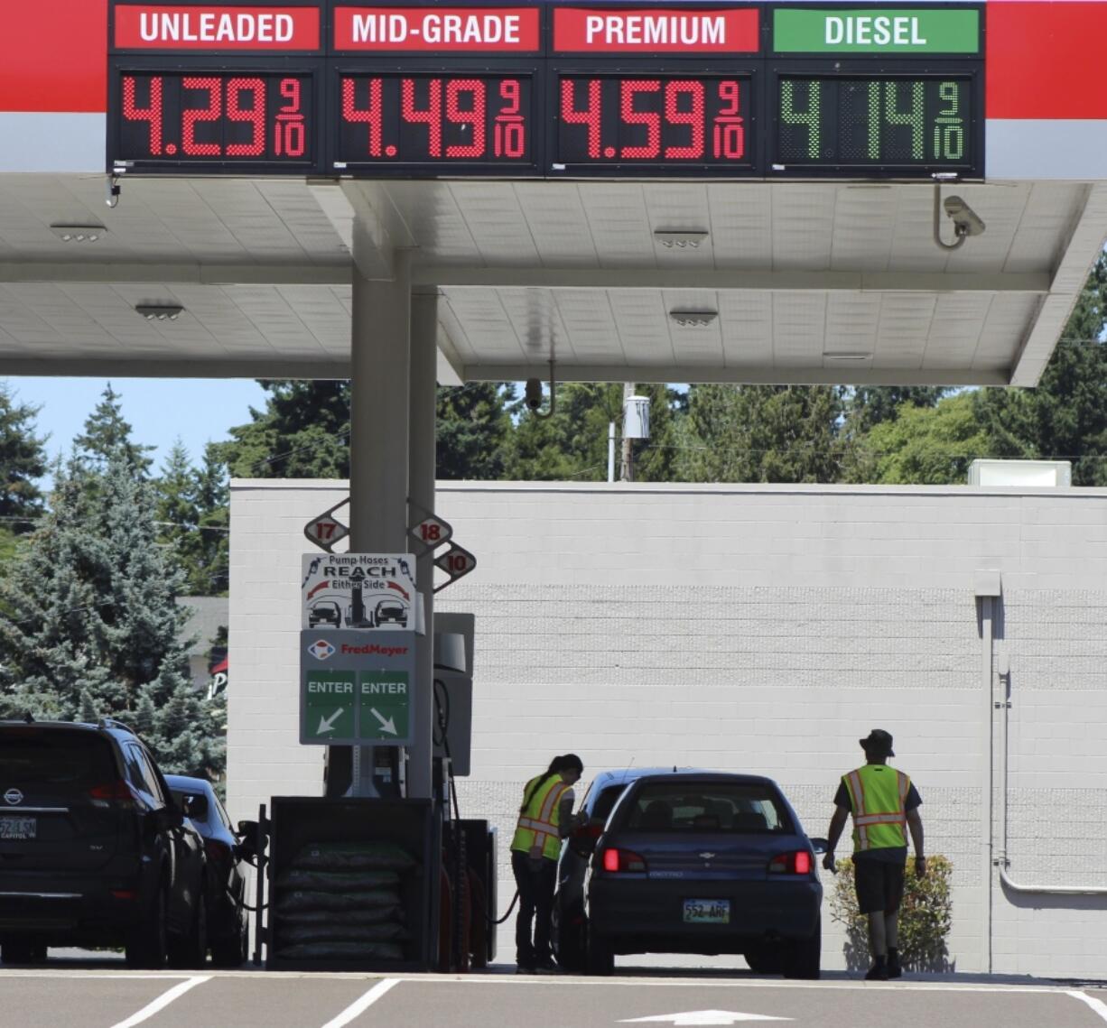 Attendants in vests service cars at a gas station in Salem, Oregon, on Thursday, June 22, 2023. In 1951, Oregon banned self-serve pumps at filling stations, being the only U.S. state besides New Jersey to do so. But now, the Oregon Legislature has decided that people across the state should be able to choose between having an attendant pump the gas or do it themselves. Gov. Tina Kotek signed the bill into law on Friday, Aug. 4, 2023, taking effect immediately.