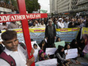 Supporters of the National Christian Party hold a demonstration condemning the recent attack on a Christian area by an angry Muslim mob in Karachi, Pakistan, Thursday, Aug. 17, 2023. Police in eastern Pakistan arrested 129 Muslims overnight after a Muslim mob angered over an alleged desecration of the Quran attacked churches and homes of minority Christians, prompting authorities to summon soldiers to restore order, officials said.